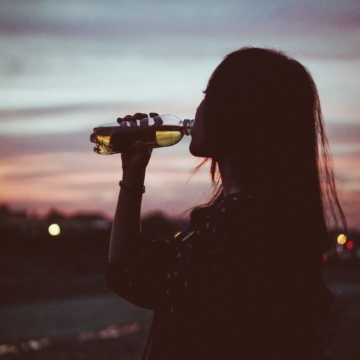 silhouette photo of woman drinking water