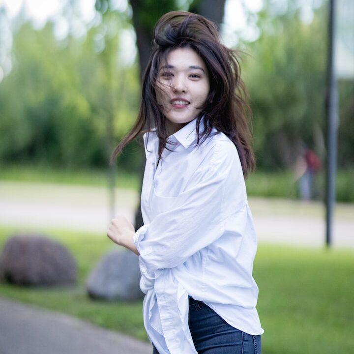 a woman walking on a sidewalk